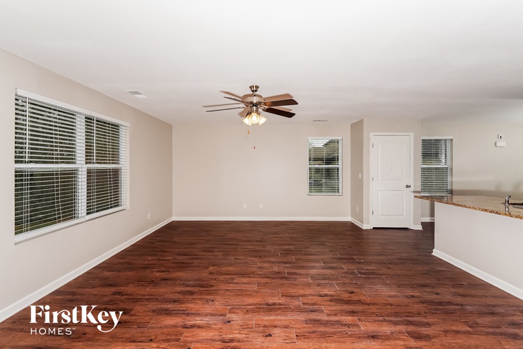 A room with a wooden floor and a ceiling fan.