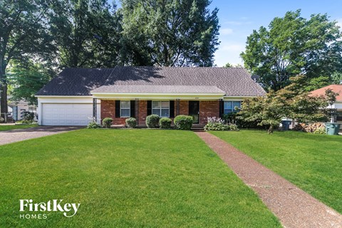 A house with a lawn in front of it.