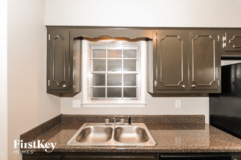 A kitchen with a sink and a window.