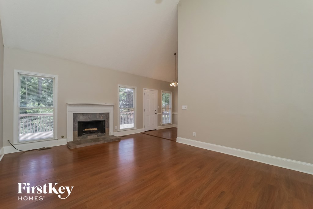 a living room with wood floors and a fireplace