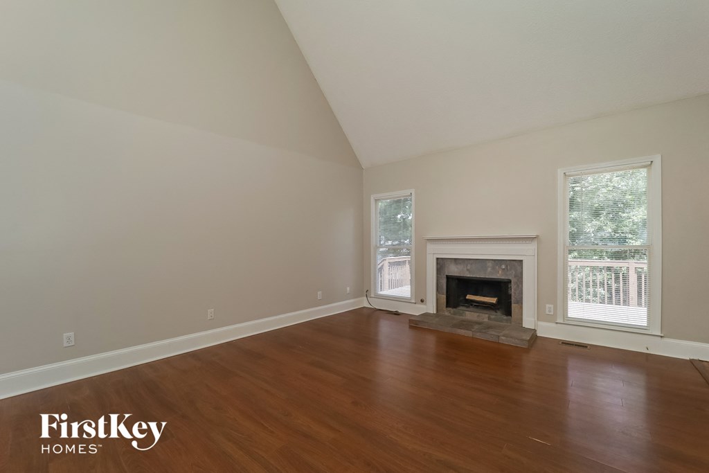a living room with wood floors and a fireplace