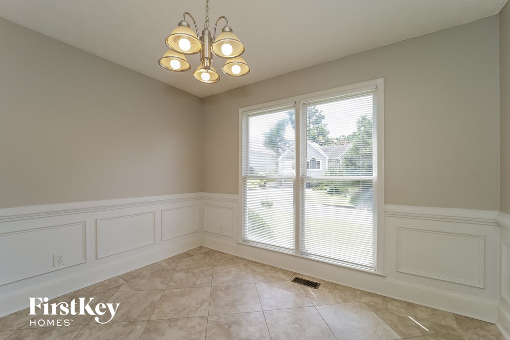 an empty dining room with a large window