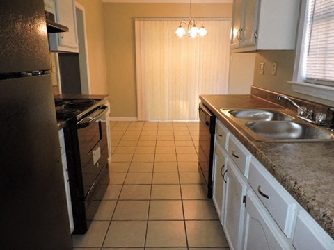 a kitchen with a sink and a stove