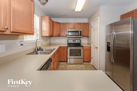 A kitchen with wooden cabinets and stainless steel appliances.