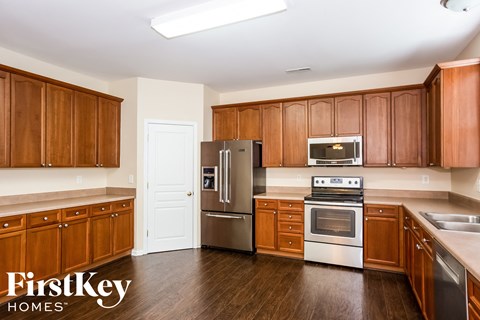 A kitchen with wooden cabinets and stainless steel appliances.