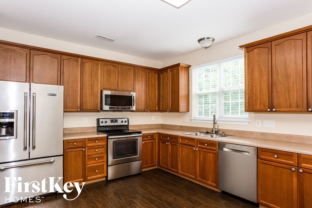 A kitchen with wooden cabinets and stainless steel appliances.