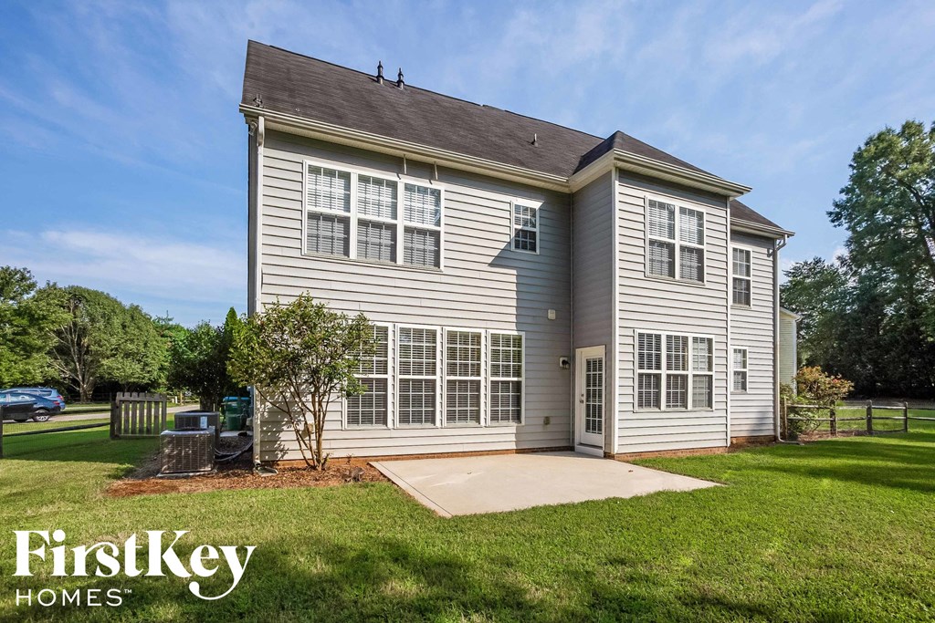 A house with a grey exterior and a white window is shown.