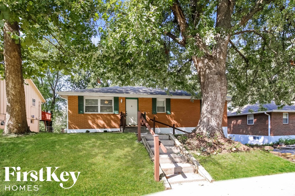 a house with a large tree in front of it