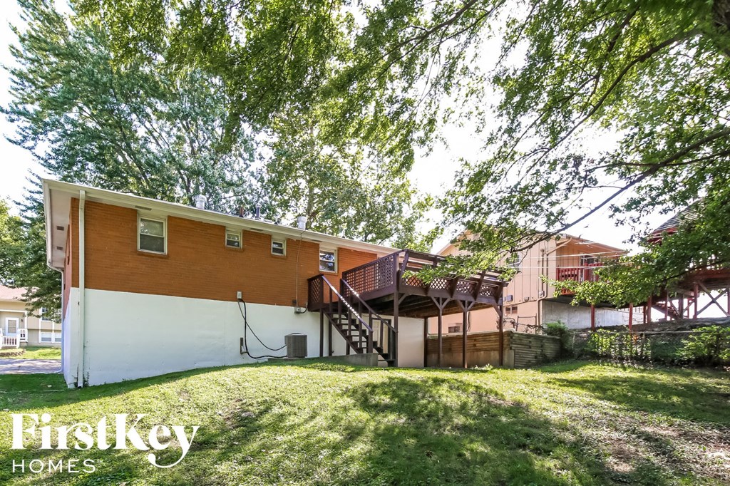 a home with a large yard and a staircase
