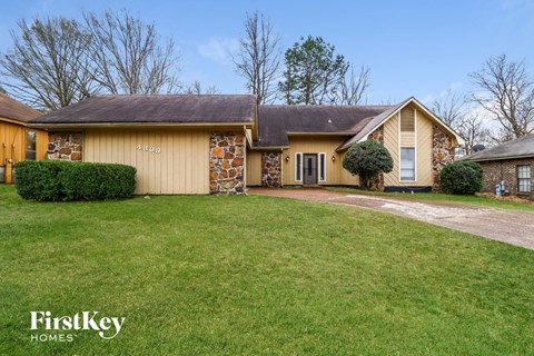 A house with a lawn in front of it.
