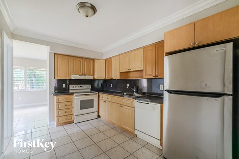 a kitchen with wooden cabinets and white appliances