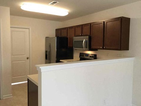 a kitchen with a counter and a refrigerator