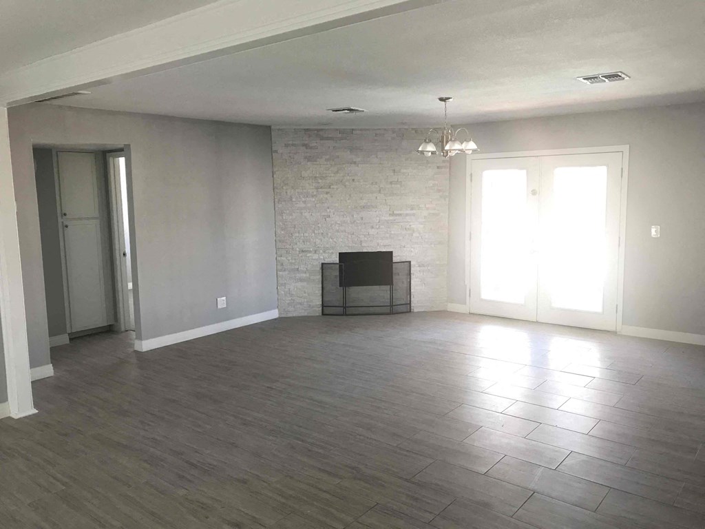 A living room with a fireplace and a television.