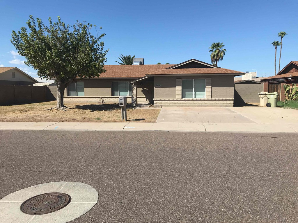 A house with a tree in front of it.