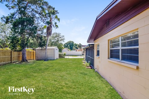 a backyard with a yard and a fence and a house