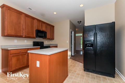 a kitchen with black appliances and wooden cabinets
