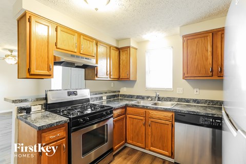 A kitchen with wooden cabinets and stainless steel appliances.