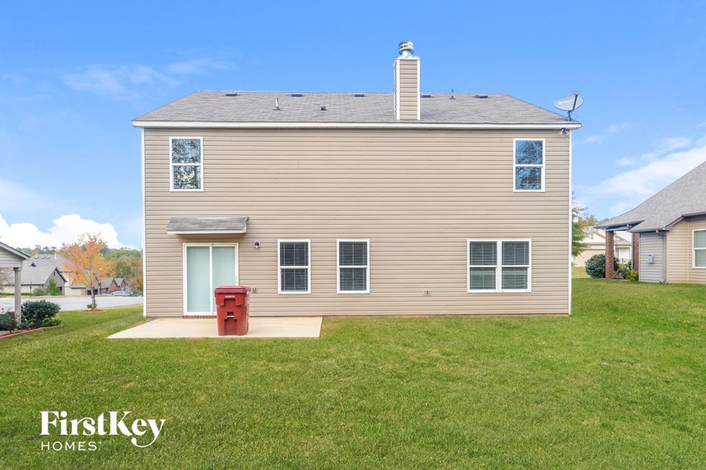 a house with a red trash can in front of it