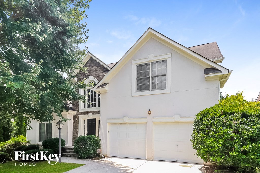a white house with a white garage door