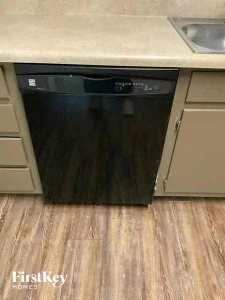 a black dishwasher sitting under a kitchen counter