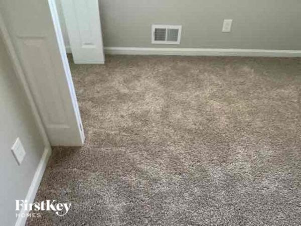 a carpeted floor in a room with an open door