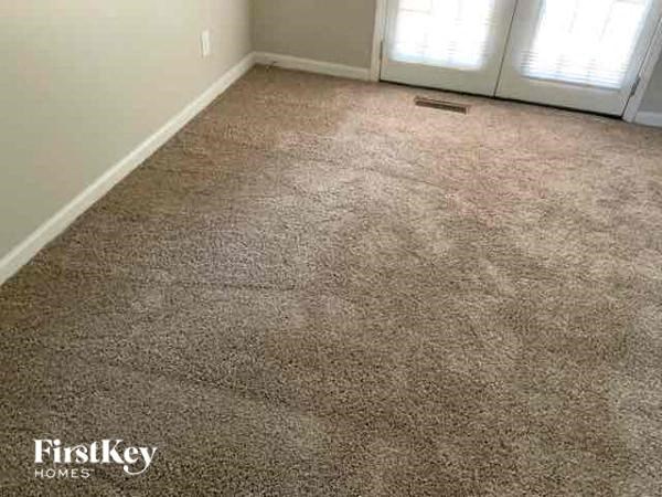 a carpeted floor in a room with a door