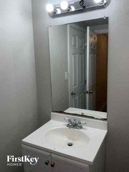 a bathroom with a white sink and a mirror