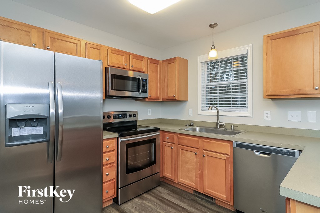 a kitchen with stainless steel appliances and wooden cabinets