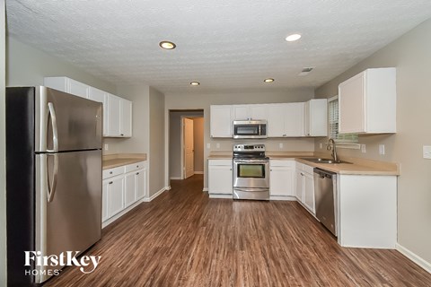 A kitchen with wooden floors and stainless steel appliances.