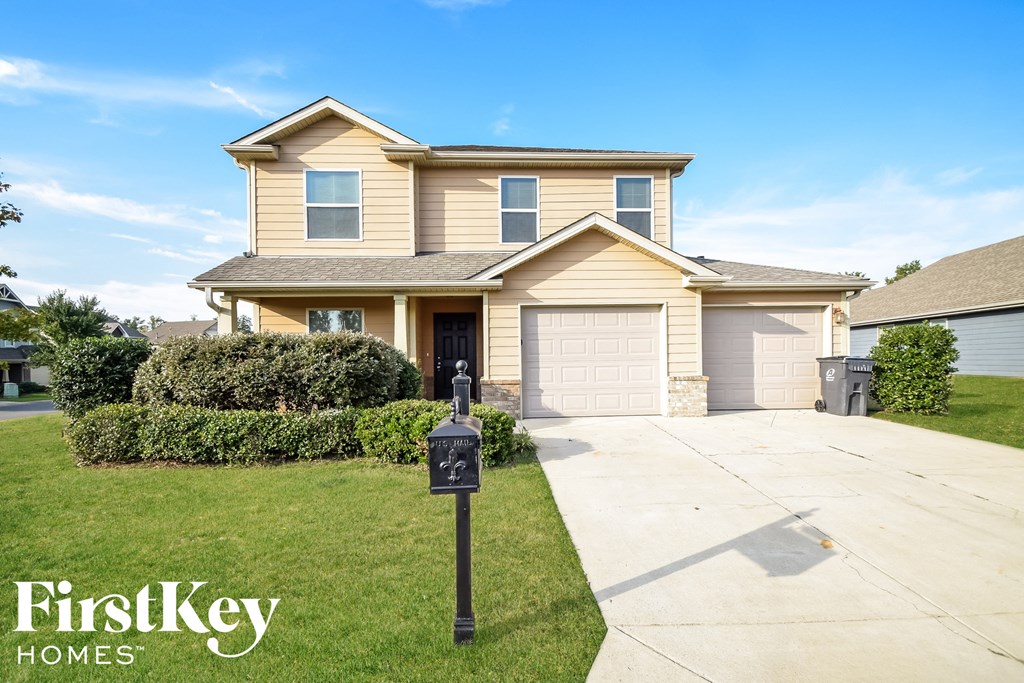a house with a garage and a parking meter in front of it