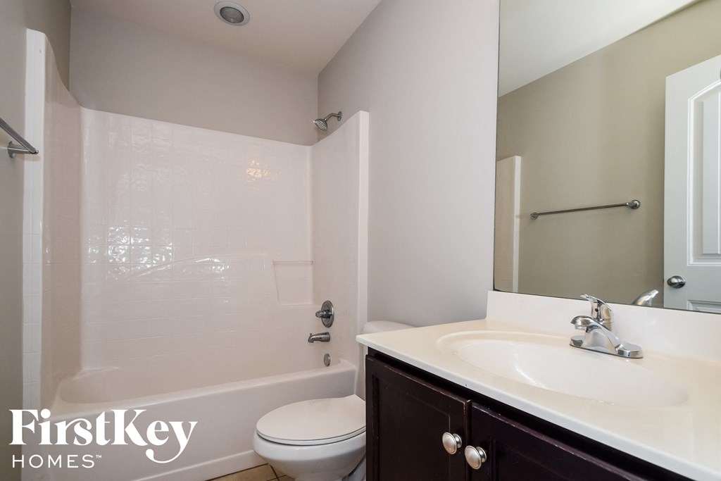 a bathroom with a sink and a toilet and a shower