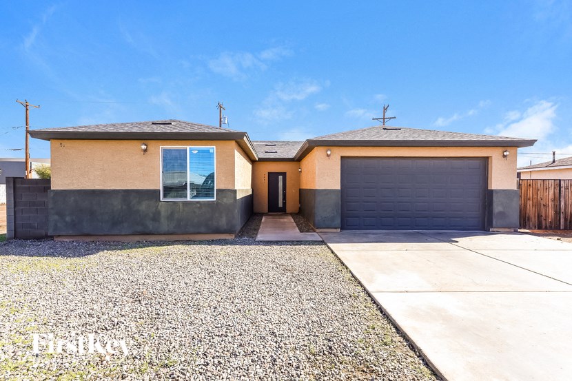 A house with a garage and a gravel driveway.