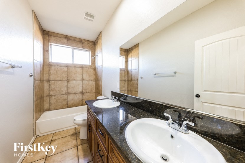 A bathroom with a sink, toilet, and tub.