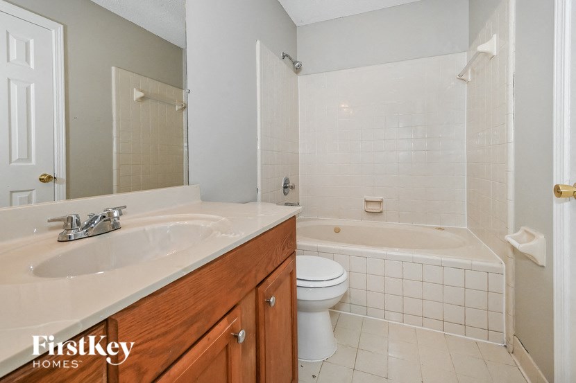 a bathroom with a sink toilet and a bath tub