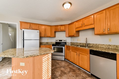 a kitchen with stainless steel appliances and granite counter tops