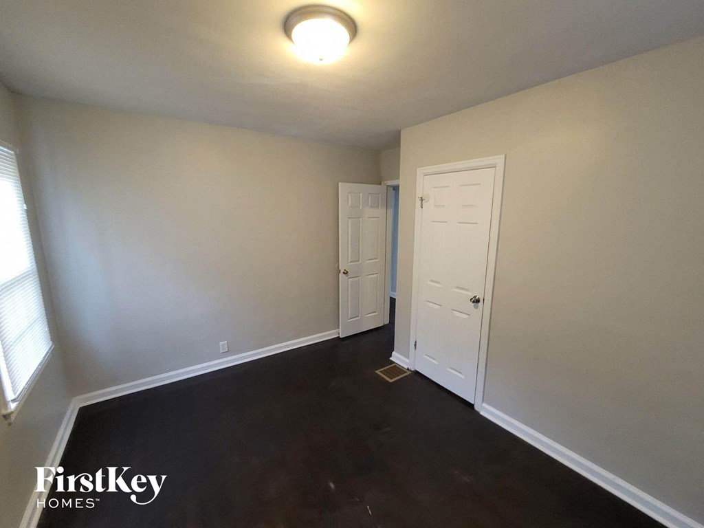 a empty room with white walls and a white door