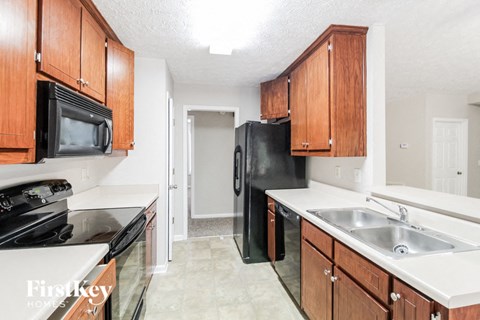 a kitchen with black appliances and wooden cabinets