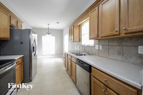 a kitchen with wooden cabinets and stainless steel appliances