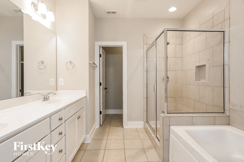 a bathroom with a sink and a shower and a tub