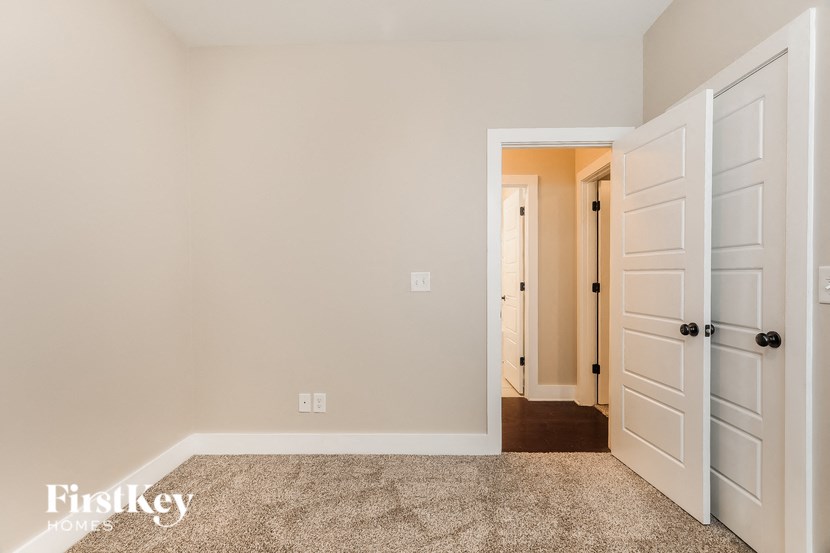 a bedroom with two closets and a door to a hallway
