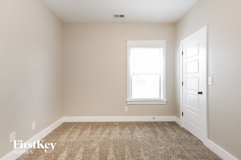 a empty room with a white door and a window