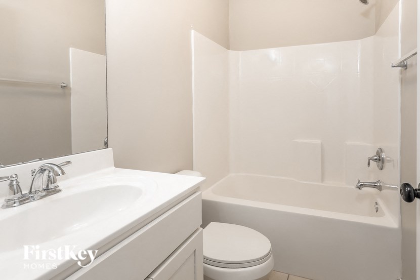 a bathroom with a sink toilet and a tub