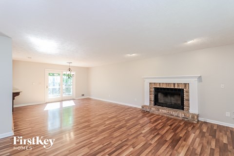 the living room has a fireplace and hardwood floors