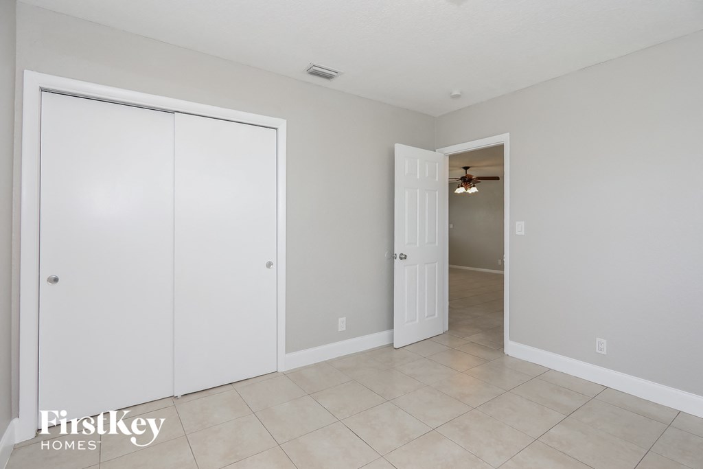 a bedroom with two closets and a hallway with a door to a closet