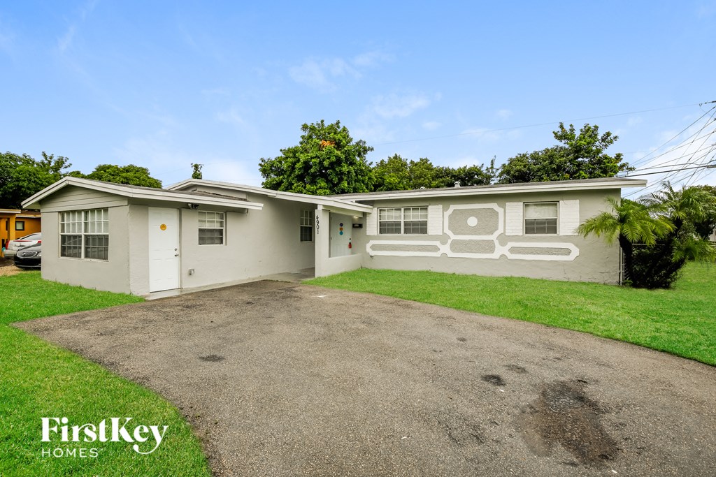 a white house with a driveway and a garage door