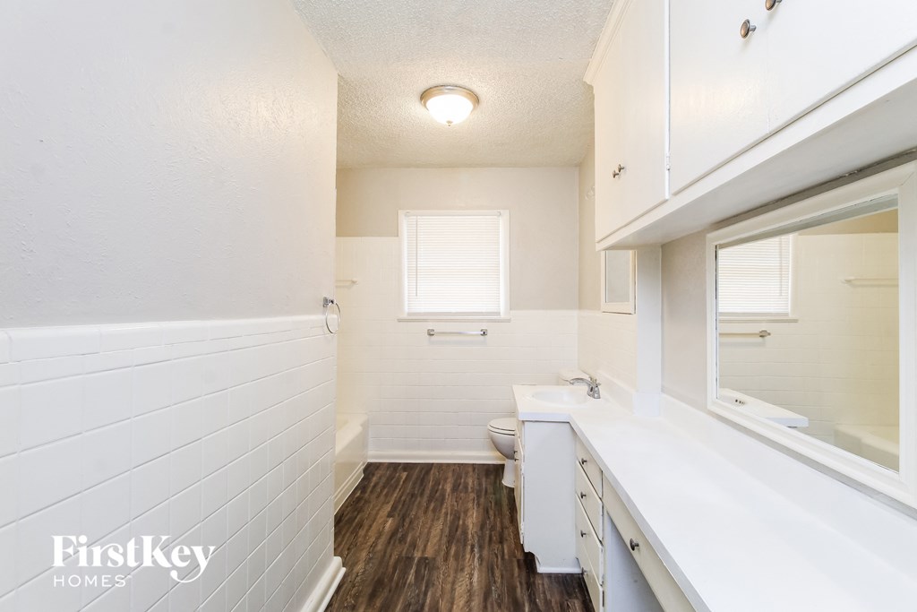 a bathroom with a toilet and a sink and a mirror
