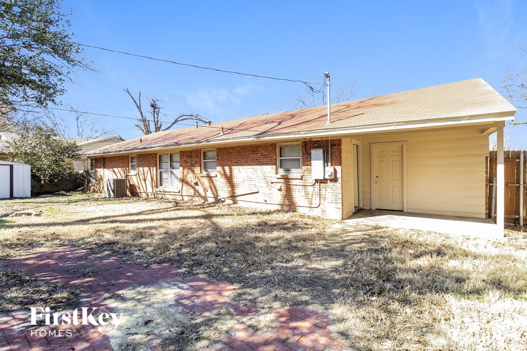 a small yellow house with a yard and a white door