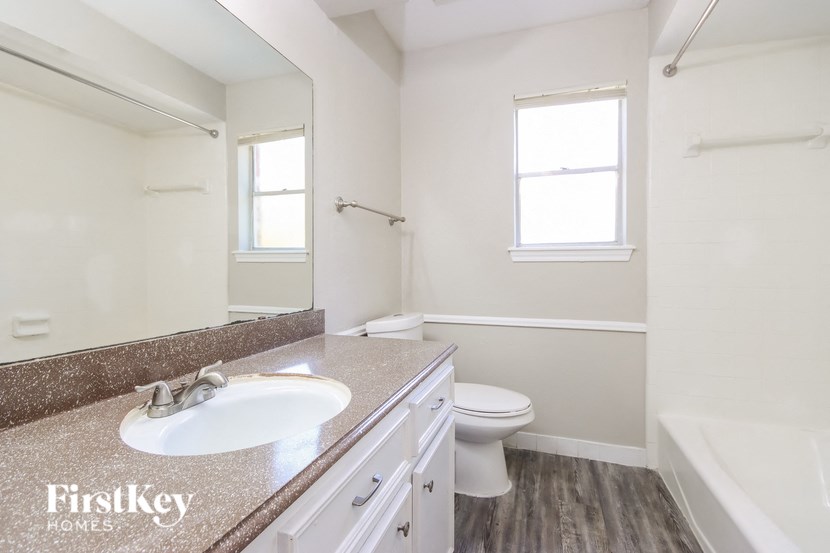 a white bathroom with a sink and a toilet