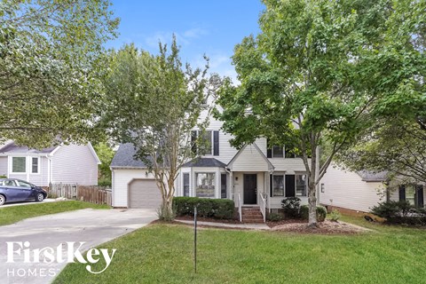 a white house with trees in front of it