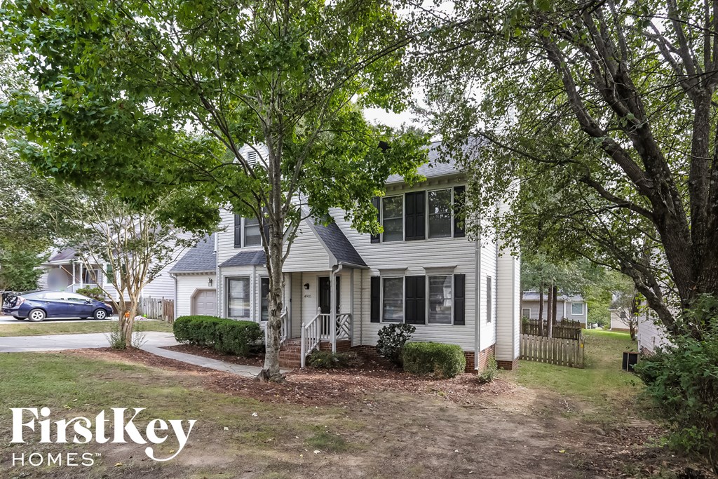 a white house with trees in front of it